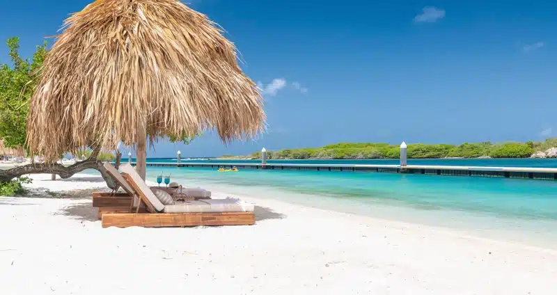 Strandbedden onder rieten parasol in Curaçao